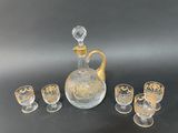 four glasses and a decanter on the table