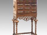 an old wooden cabinet with drawers and a drawer on top of it