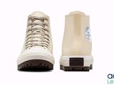 the back of a pair of white sneakers with laces on them