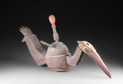 un gros plan sur une sculpture représentant un oiseau posée sur une table