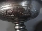 a close up of a silver cup on a table