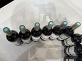 several bottles of wine are lined up in a plastic container