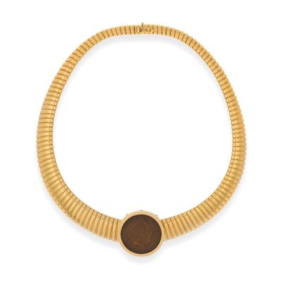 a close up of a gold necklace with a brown stone