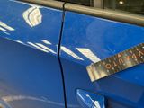 a sticker on the door of a blue car that has a sticker on it
