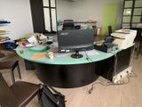a desk that has a laptop on it in the middle of the room