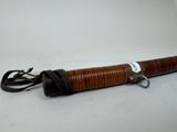 an old wooden umbrella with a black handle on a white background
