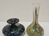 two vases that are sitting on a table