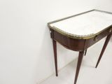 a small table that has a marble top on it