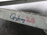 a close up of a metal bench with graffiti on it