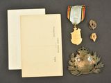 a book, medal, and other items that are on a table