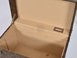 a brown and tan suitcase with a handle on a white surface