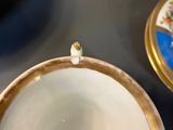 a close up of a cup and saucer on a table