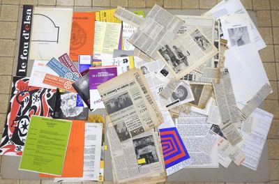 a pile of newspapers and other papers on the floor