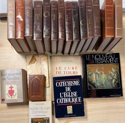 several books on a table with a lot of books on top of it