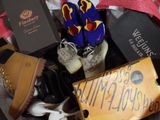 many pairs of shoes and a sign in a suitcase