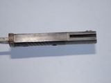 a metal object that is laying on a white surface