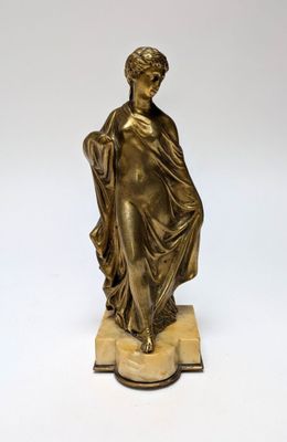 an antique bronze statue of a woman holding a basket