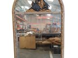 an image of a large mirror with a statue on top of it