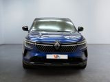 the front view of a blue car in a white room