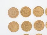six different types of gold coins on a white surface