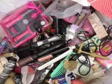 a bag full of makeup and hair products on the floor