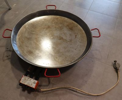 a large pan that is sitting on the floor next to a hose