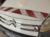 a white van with a red and white stripe on the hood