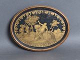 a gold plate with a picture of a man and a woman on it