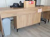 a wooden desk with a computer on top of it