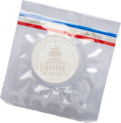 the coin is in a clear plastic bag on a white surface