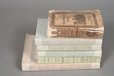 several books stacked on top of each other on a table