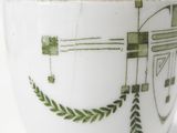 a white bowl with a green design on it
