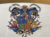 a plate with a coat of arms and a crown on it