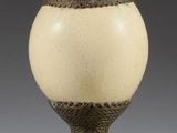 a vase that is sitting on a stand on a table