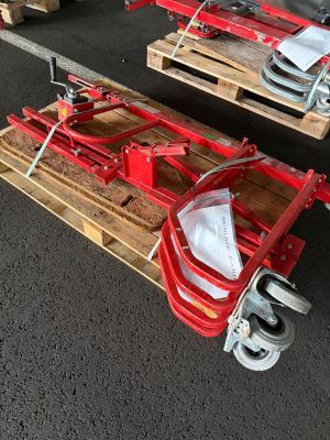 two wooden pallets with wheels attached to them