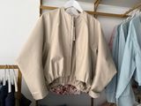 a jacket hanging on a clothes rack in a closet