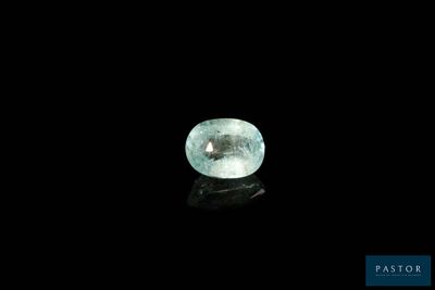 a close up of a green diamond on a black surface