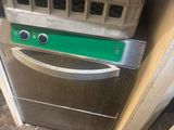 a silver oven with a green sign on it