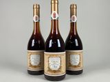 three bottles of wine sitting next to each other on a table