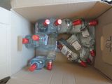 many bottles of water in a cardboard box on the floor