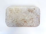 a stone with a picture of a man and a horse on it