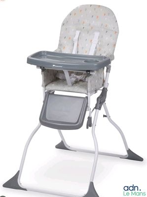 a baby high chair that has a tray in it