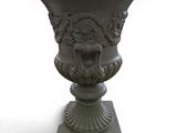 a vase with a lion head on it on a pedestal