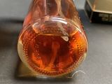 a bottle of liquid sitting on top of a table