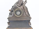 a statue of a woman sitting on top of a clock