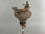a statue of a man riding a horse on top of a pole