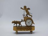 a clock with a statue of an angel and a dog on it