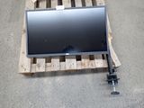 a computer monitor sitting on a pallet on the floor