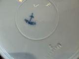 a white plate with a blue anchor on it