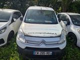 three small white cars parked in a grassy area next to trees